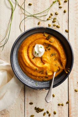 This healthy, creamy Pumpkin Ginger Soup is the perfect cozy, fall soup made creamy without adding any cream. Instead, the vegetables and Greek yogurt thicken it!