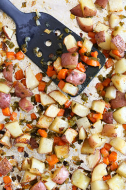Homemade breakfast potatoes made with red potatoes, onions, bell pepper and carrots all on one sheet pan. All you need is some eggs and breakfast is served!