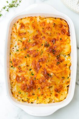 A delicious Scalloped Potato Gratin recipe made with thinly sliced Yukon gold potatoes layered with cheese and a light buttery sauce.