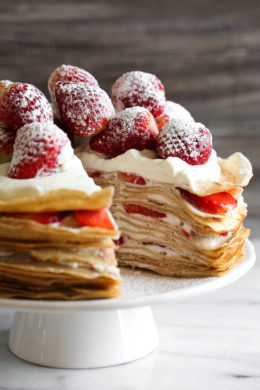Crepes aren't just for rolling, something special happens with you layer then with cream and top them with strawberries. It creates a beautiful cake-like dessert, when you slice into it, you can see all the layers.